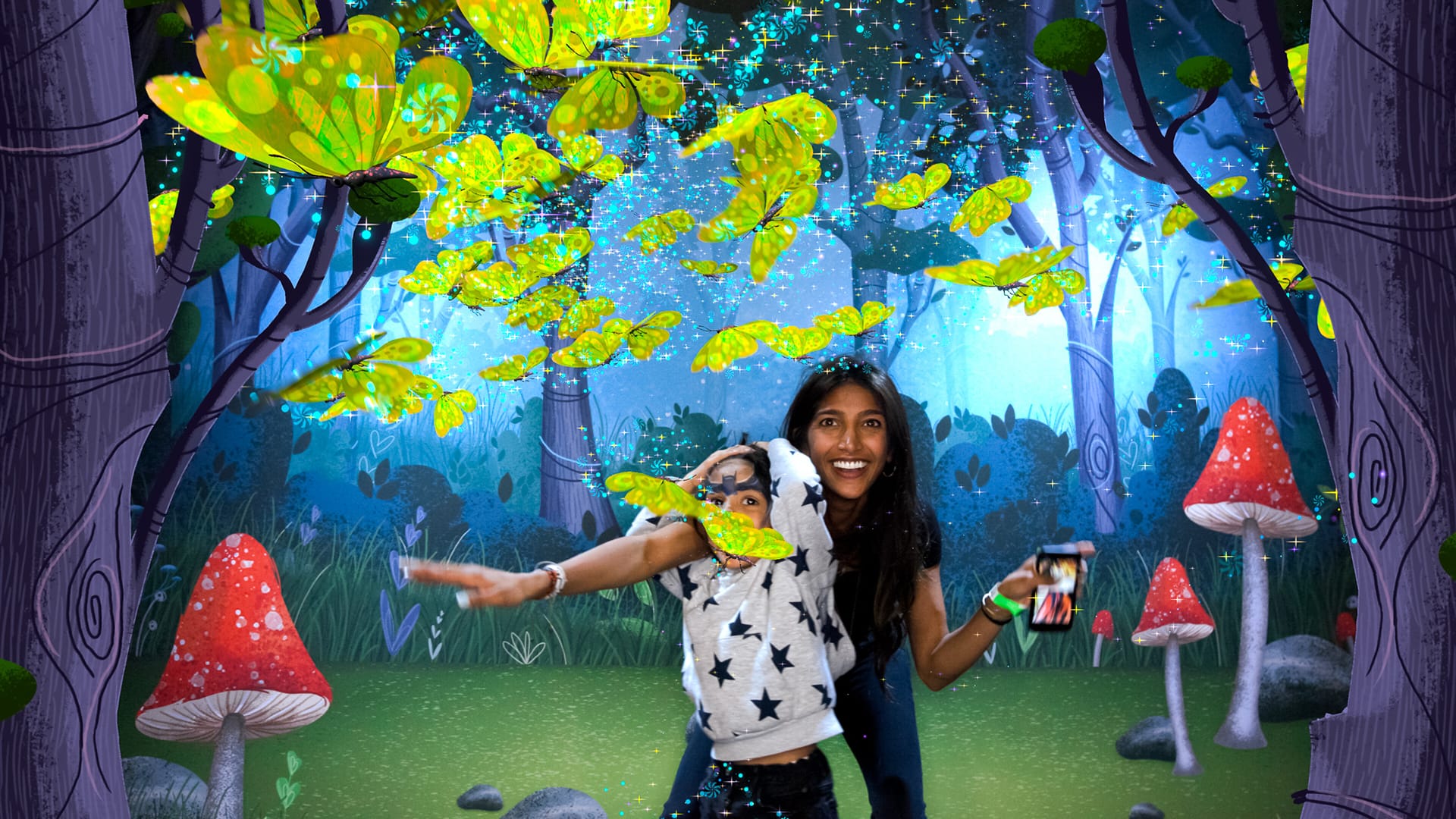 Mother and excited young son pose with animated butterflies in AR photo booth