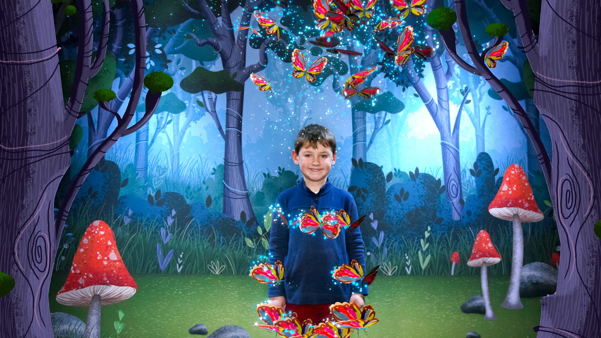 Young boy poses in the photo booth as animated butterflies rest on his arms